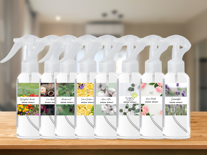 Room and linen spray bottle set with white caps, multiple scents on display