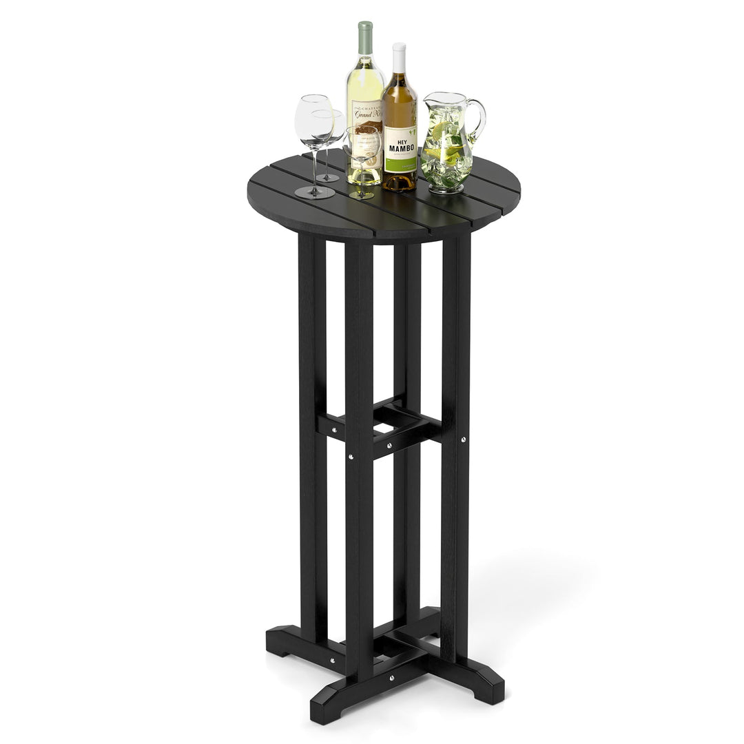 Black outdoor bar table with round top and bottle-and-glass arrangement