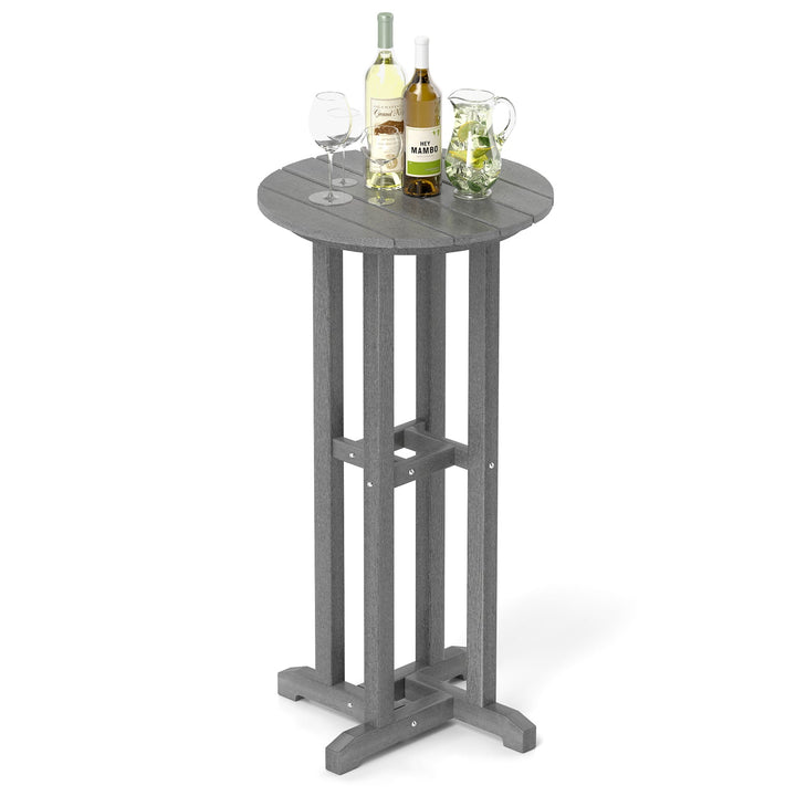Gray outdoor bar table with round top and bottle-and-glass arrangement