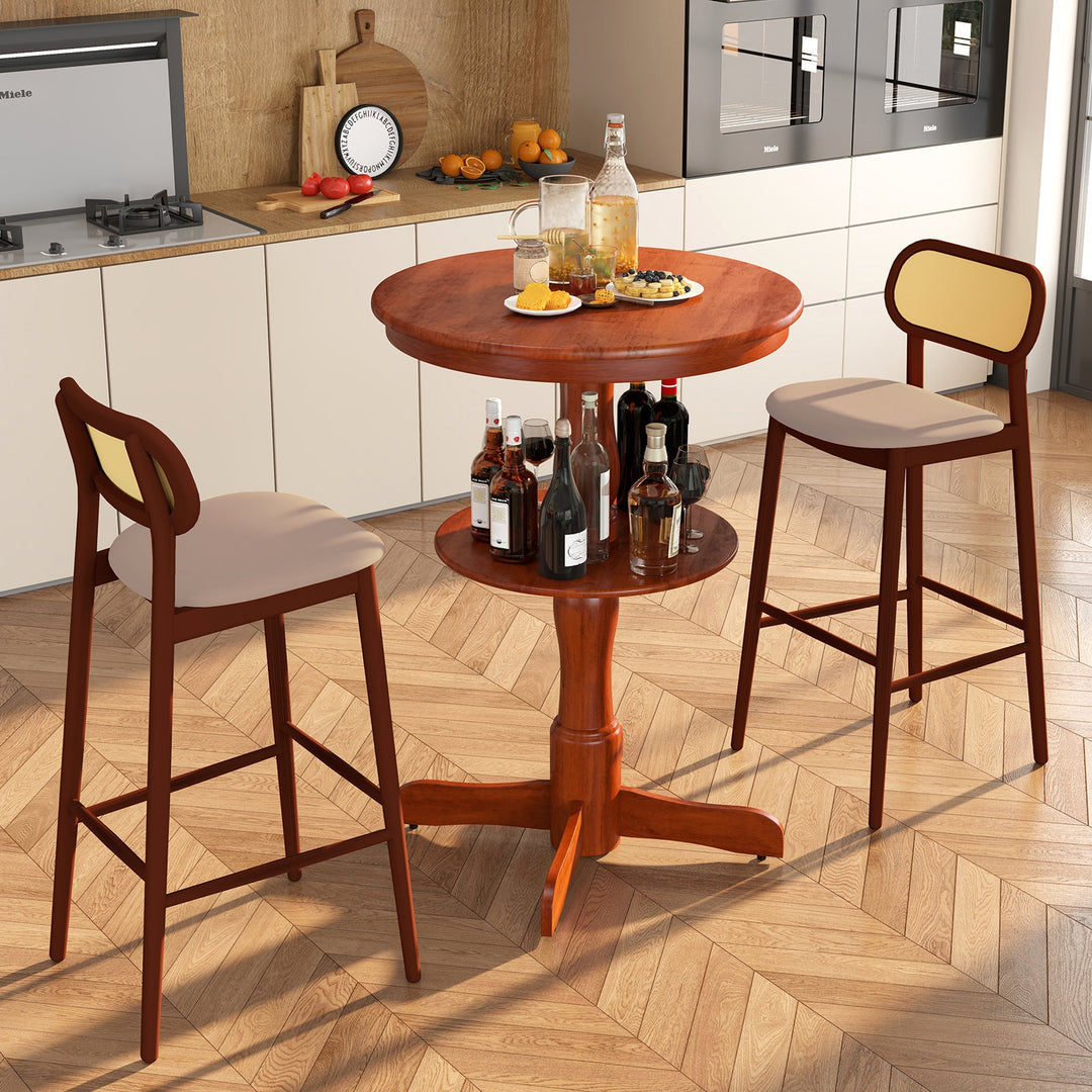 Espresso round 2-tier bar table with pedestal base beside matching stools