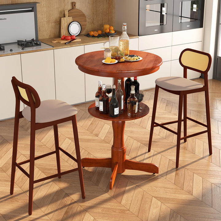 Espresso round 2-tier bar table with pedestal base beside matching stools