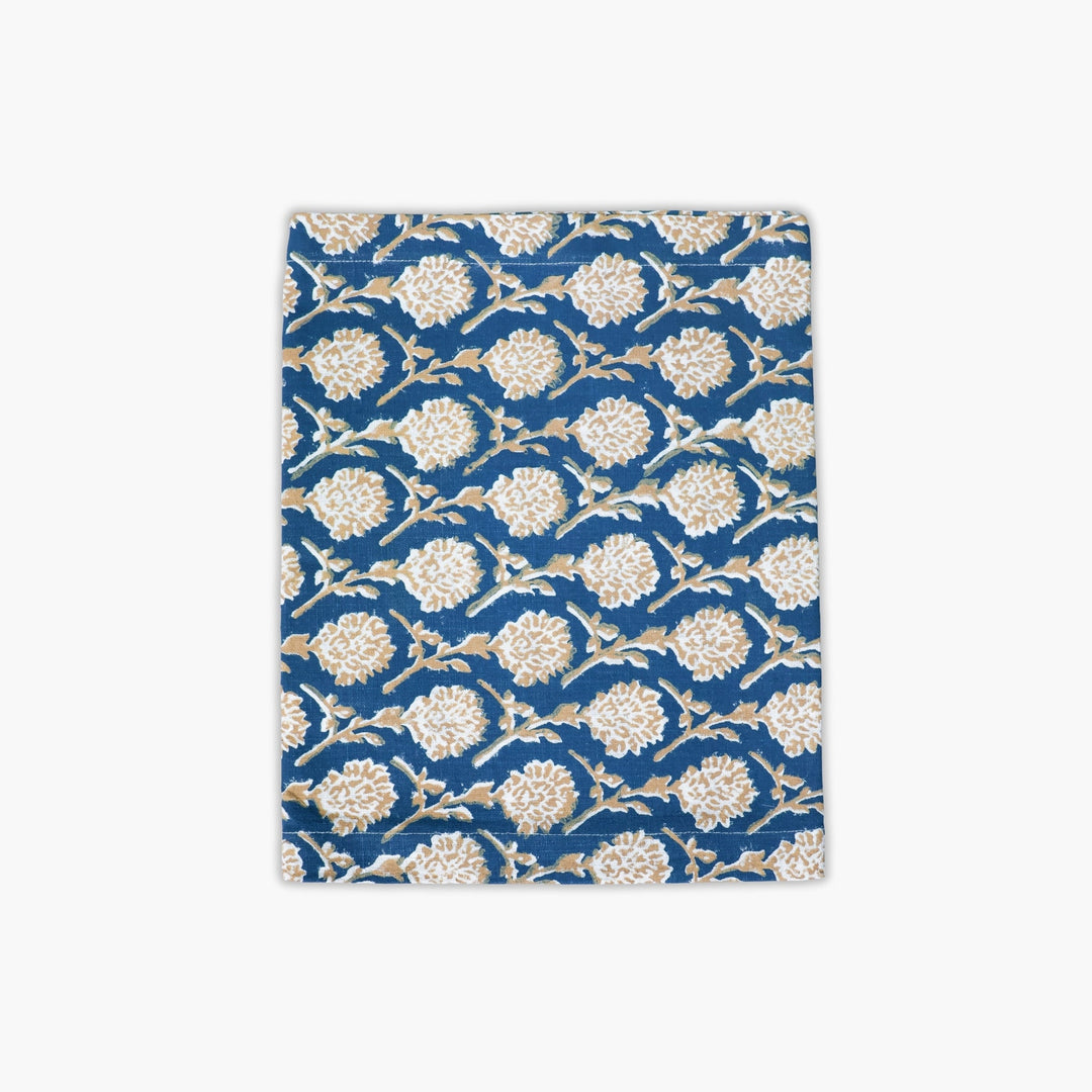 Linen runner in ink blue with gold floral hand-printed pattern, bordered edge