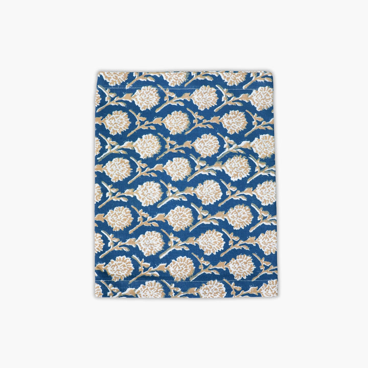 Linen runner in ink blue with gold floral hand-printed pattern, bordered edge