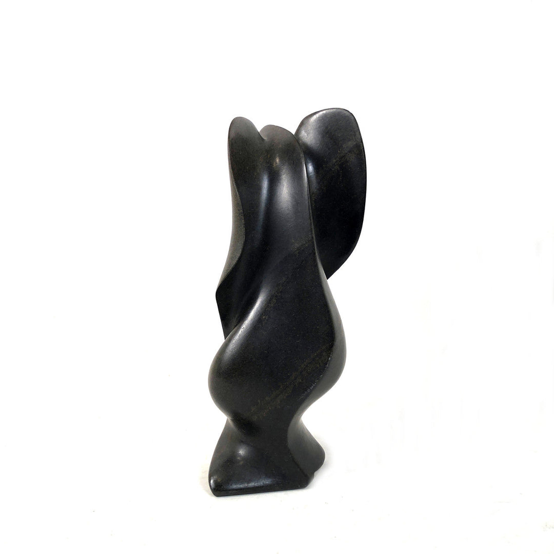 Dark gray-black stone elephant figurine, carved side view with curved trunk