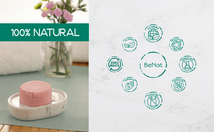 Round pink shampoo bar on a small dish with fresh flowers nearby