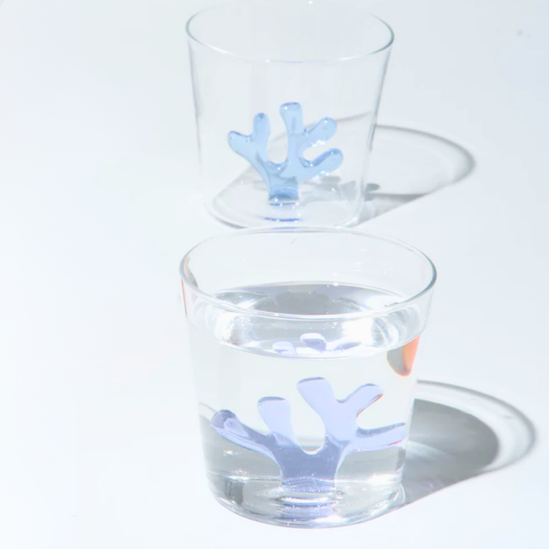Water tumbler with clear glass and light blue coral-shaped silicone insert