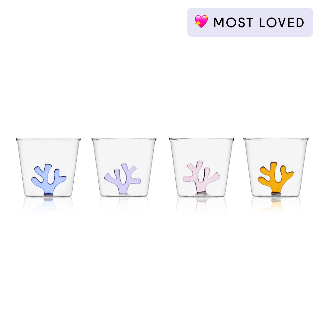 Glass water tumbler with blue coral-style silicone insert