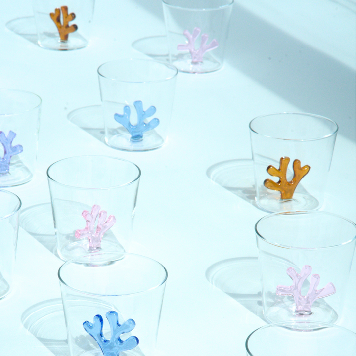 Set of clear water tumblers with coral-shaped silicone inserts in multiple colors