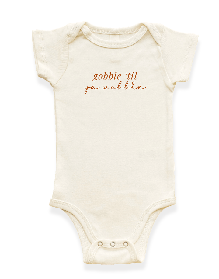 Organic baby bodysuit in cream with &