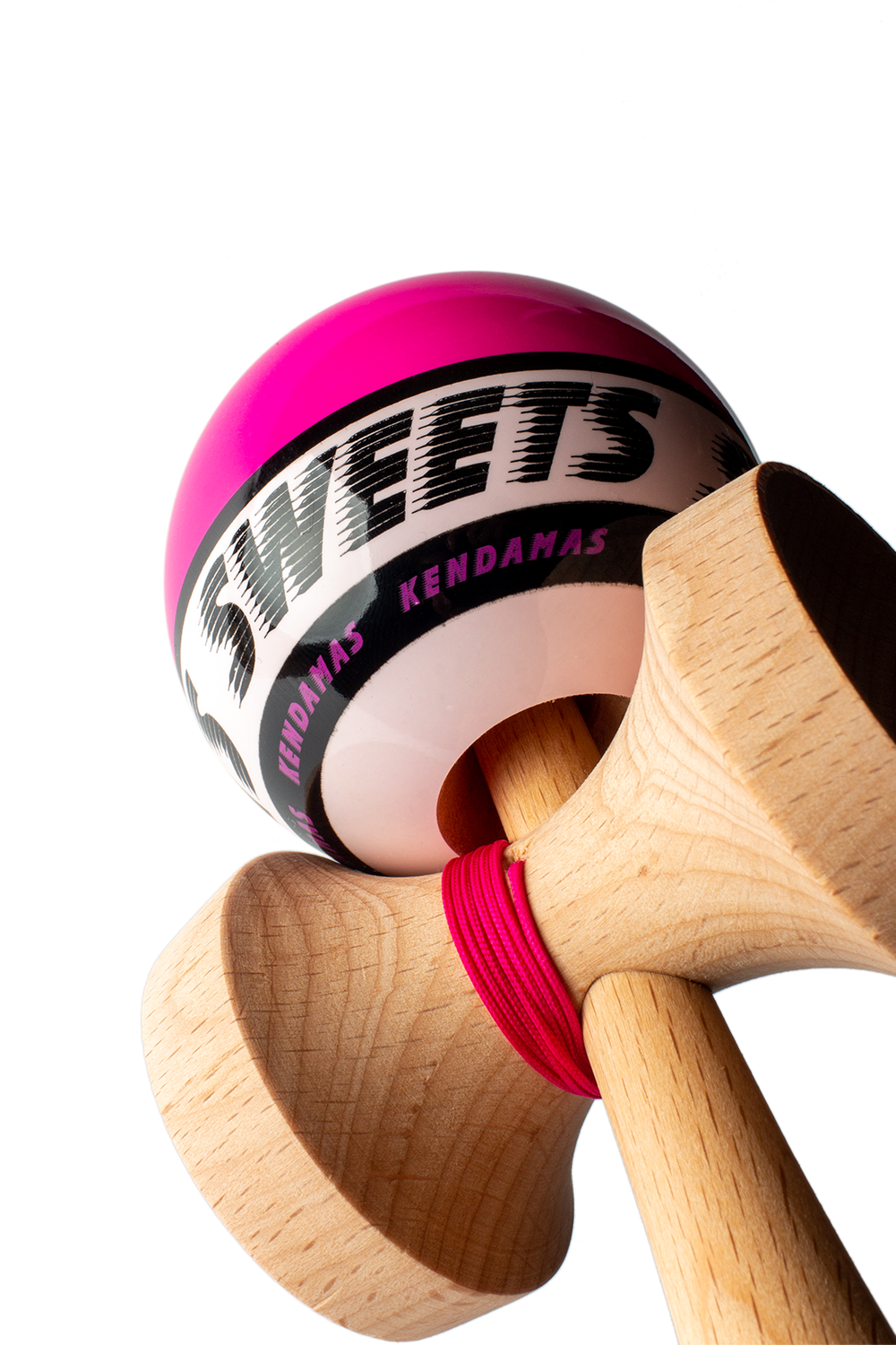 Wooden kendama with pink ball and black logo band, shown from side