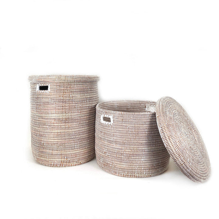 Round woven floor baskets with flat lids; one lid rests beside the basket, light neutral