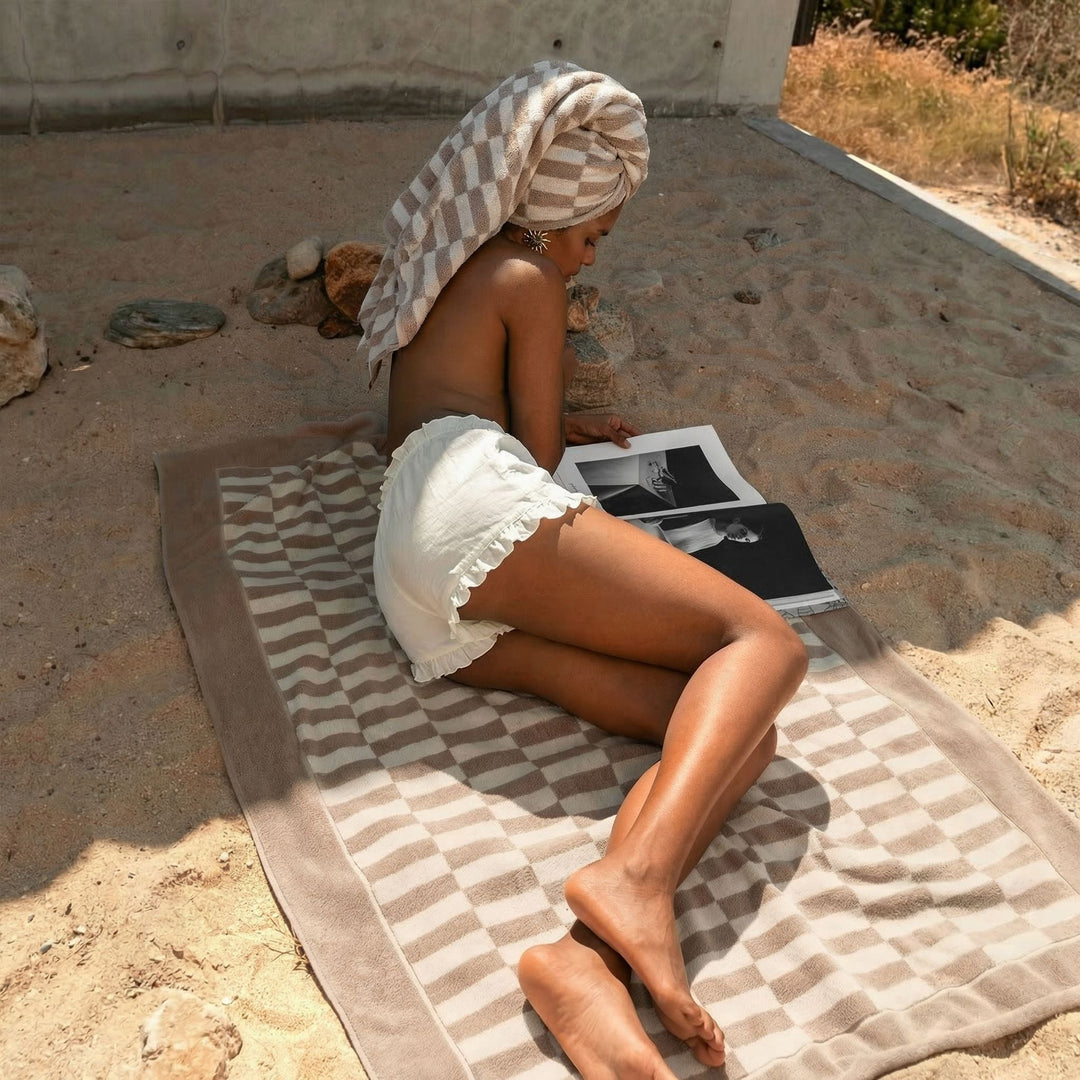 Cotton towel with tan and white check pattern, used as a wrap on the beach