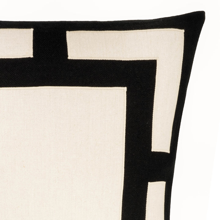 Black and white geometric throw pillow corner detail with thick border and small blocks