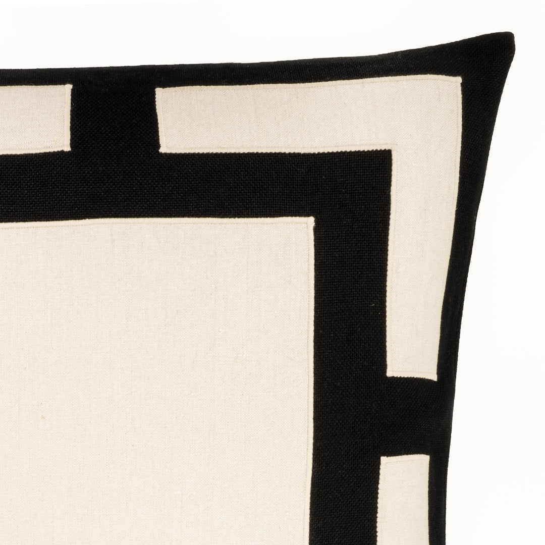 Black and white geometric throw pillow close-up of layered square and contrast blocks
