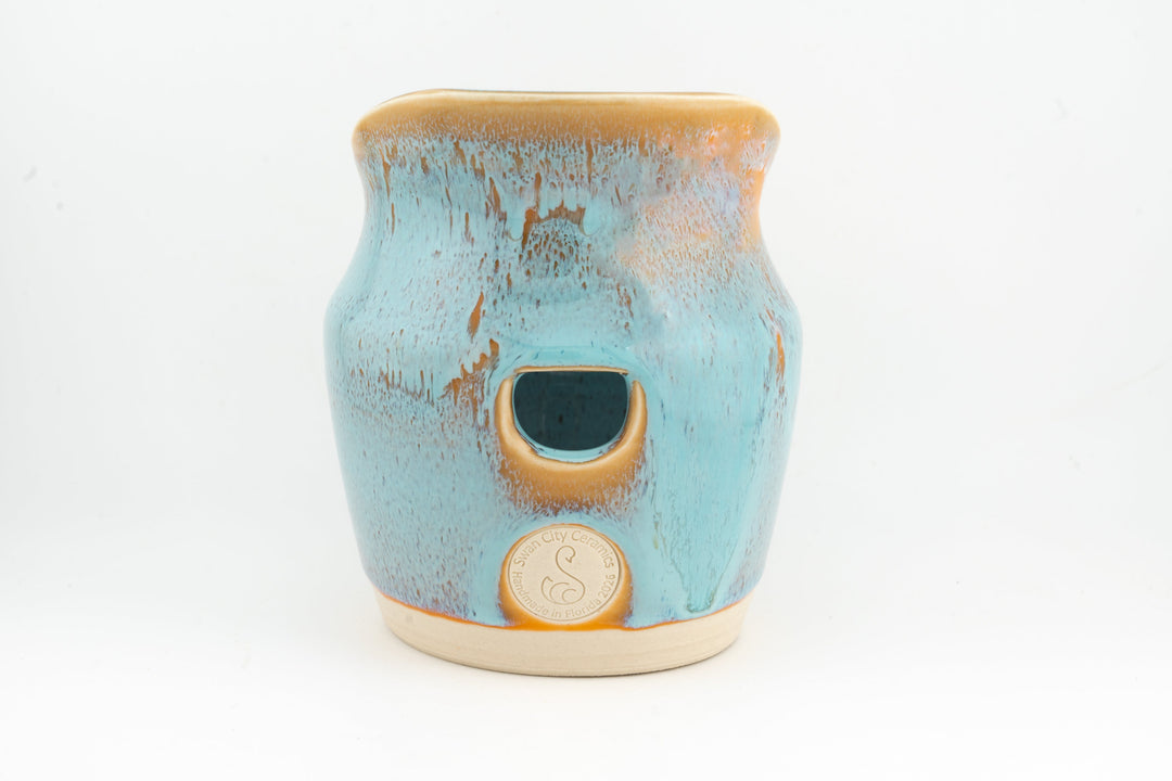Ceramic dried flower sconce with side cutout, aqua blue glaze with tan rim, cream base