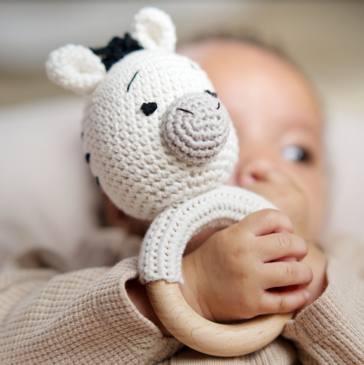 Organic cotton rattle ring teether with zebra face, black accents, wooden ring