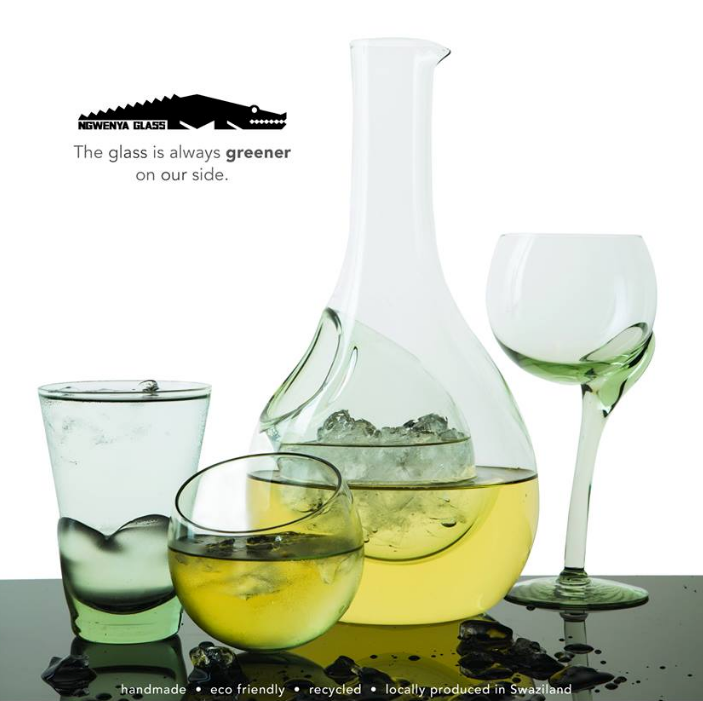 Green-tinted decanter with crooked-stem wine glasses in matching set.