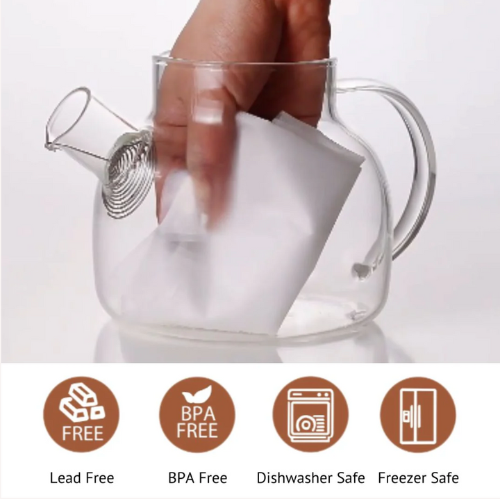 Glass tea steeper with bamboo-style lid being lifted by a hand