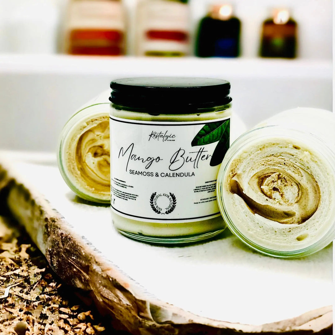 Mango butter jar with open lid and swirl of pale yellow cream, plus another tub