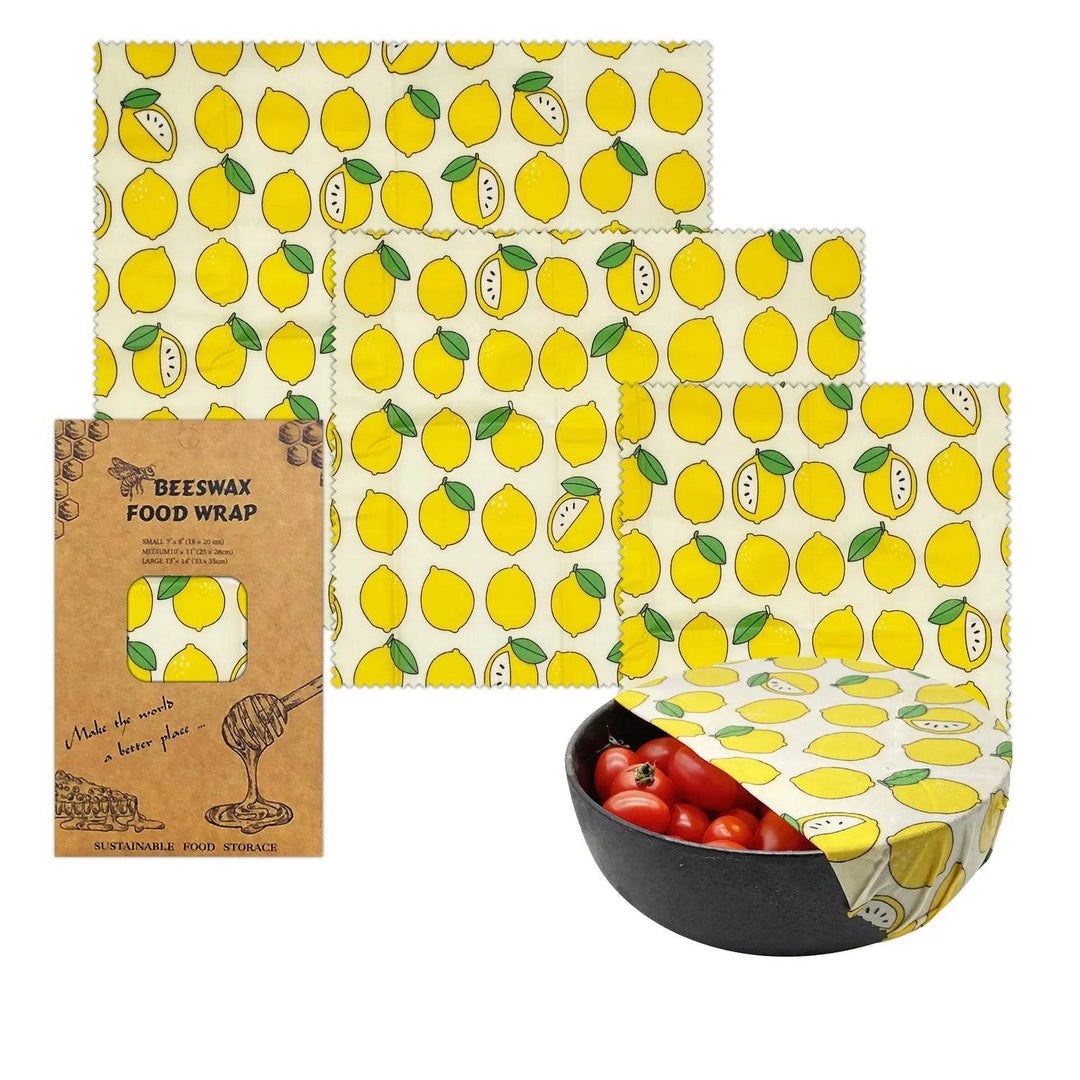 Beeswax food wrap set with yellow lemon pattern, shown folded and in use on a bowl