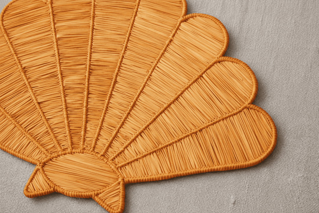 Handwoven shell placemat in natural blush beige with ridged woven texture