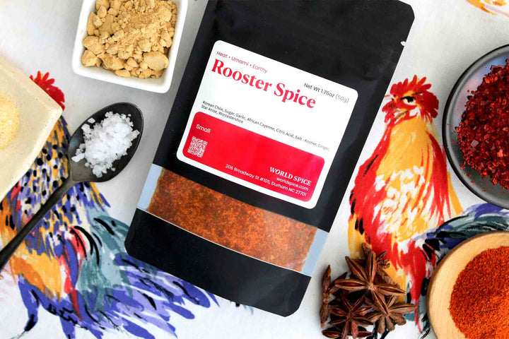 Rooster Spice pouch with red label and rooster illustration, surrounded by spices
