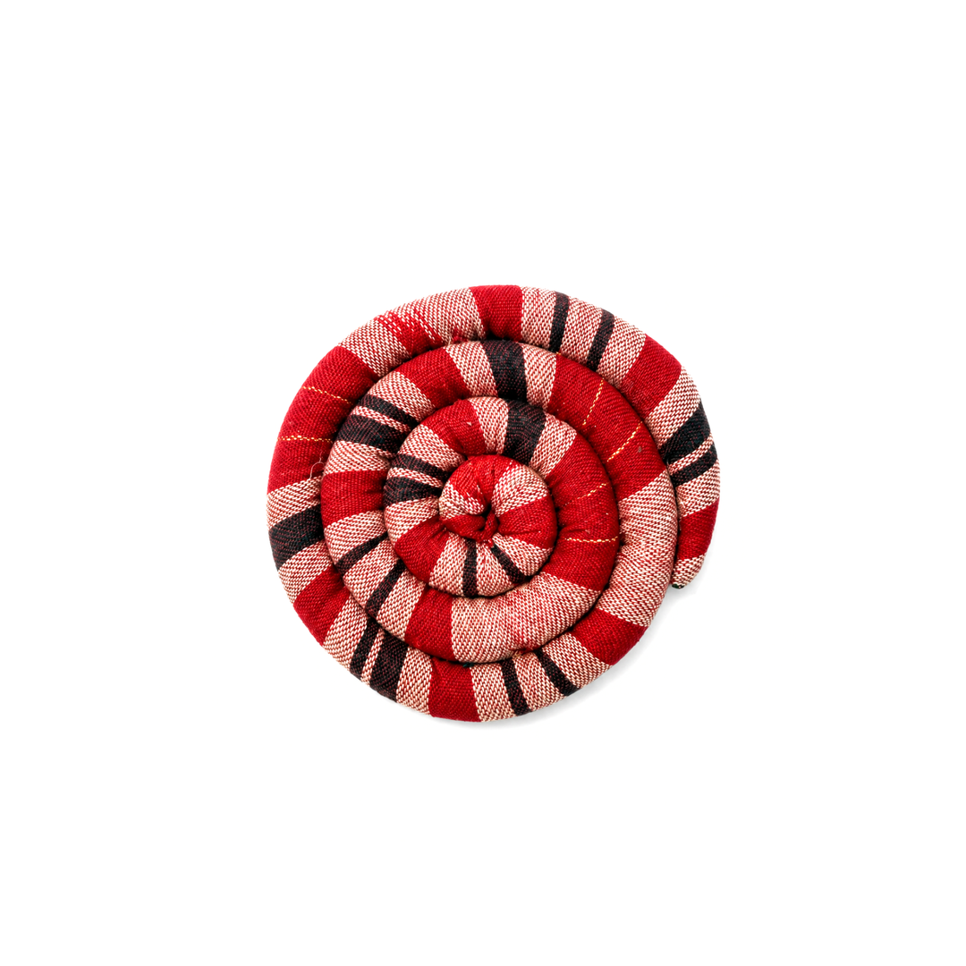Round spiral trivet with red and tan plaid stripes and stitched rosette center