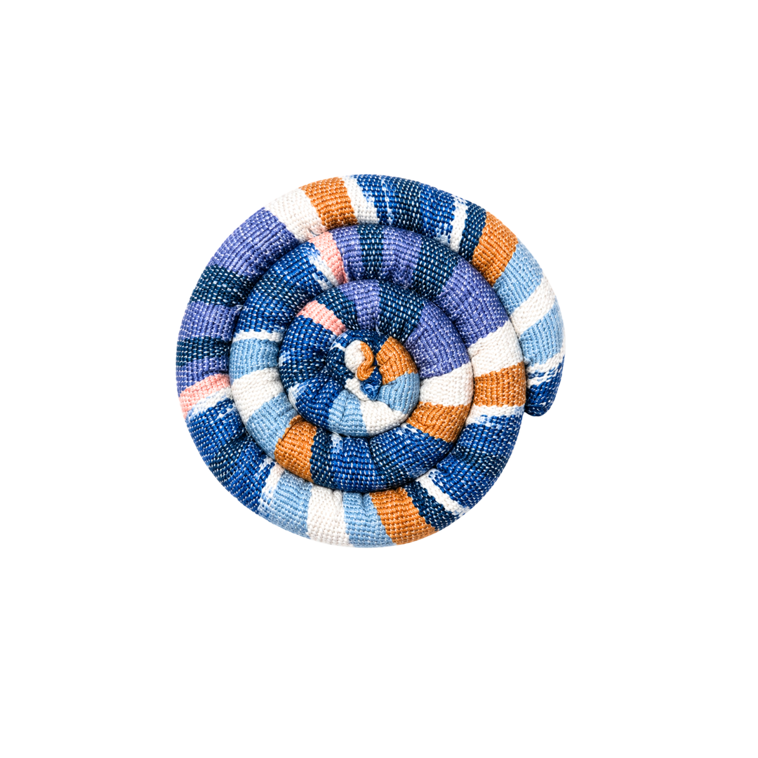 Round spiral trivet with blue, orange, and cream plaid stripes and stitched rosette center