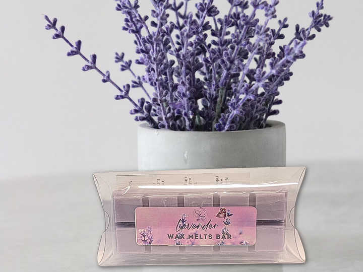 Lavender wax melt bar pack in clear wrap with lavender stems in a gray vase