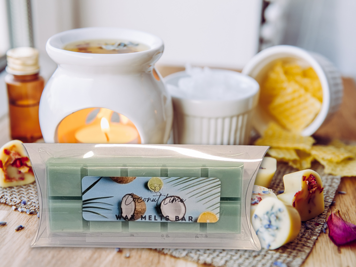 Wax melts bar in clear packaging with green bars, set on a wooden surface