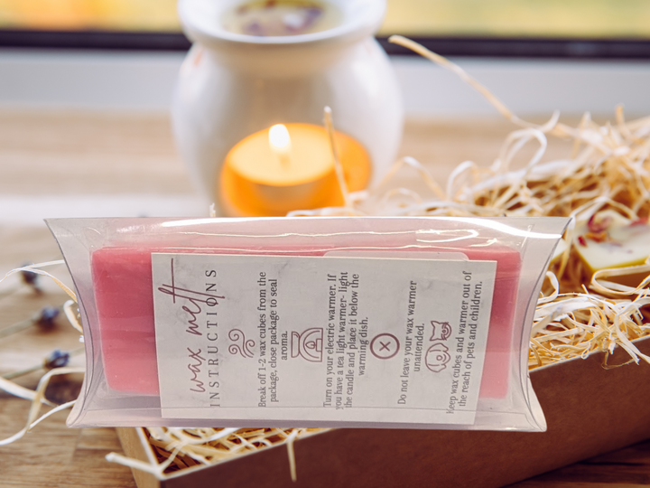 Pink wax melts bar in clear wrap with printed label on the front