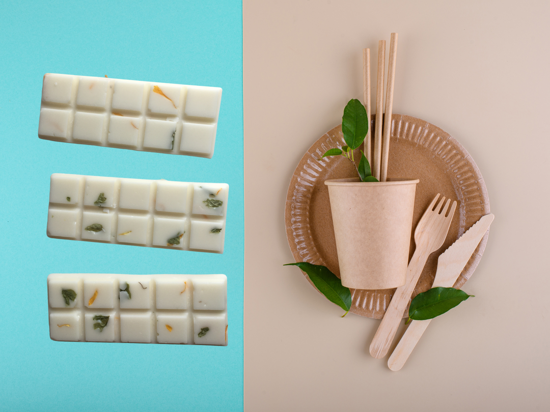 Sliced wax melts bars and a kraft holder with wooden sticks and green leaves