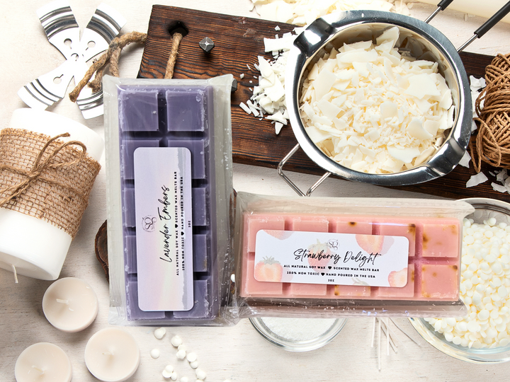 Assorted wax melts bars in clear packaging with a purple bar and a pink bar