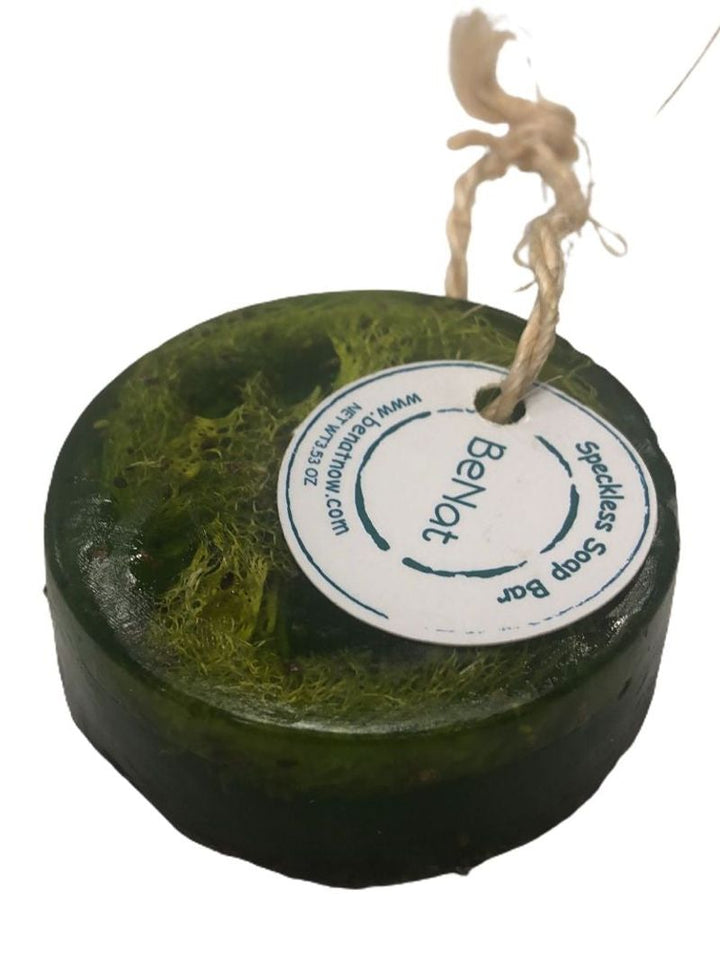 Dark green round soap bar with white circular label and hanging rope