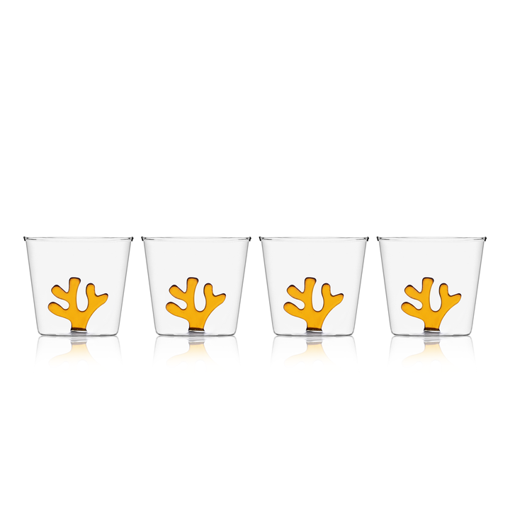 Set of four clear glass water tumblers with orange coral inserts