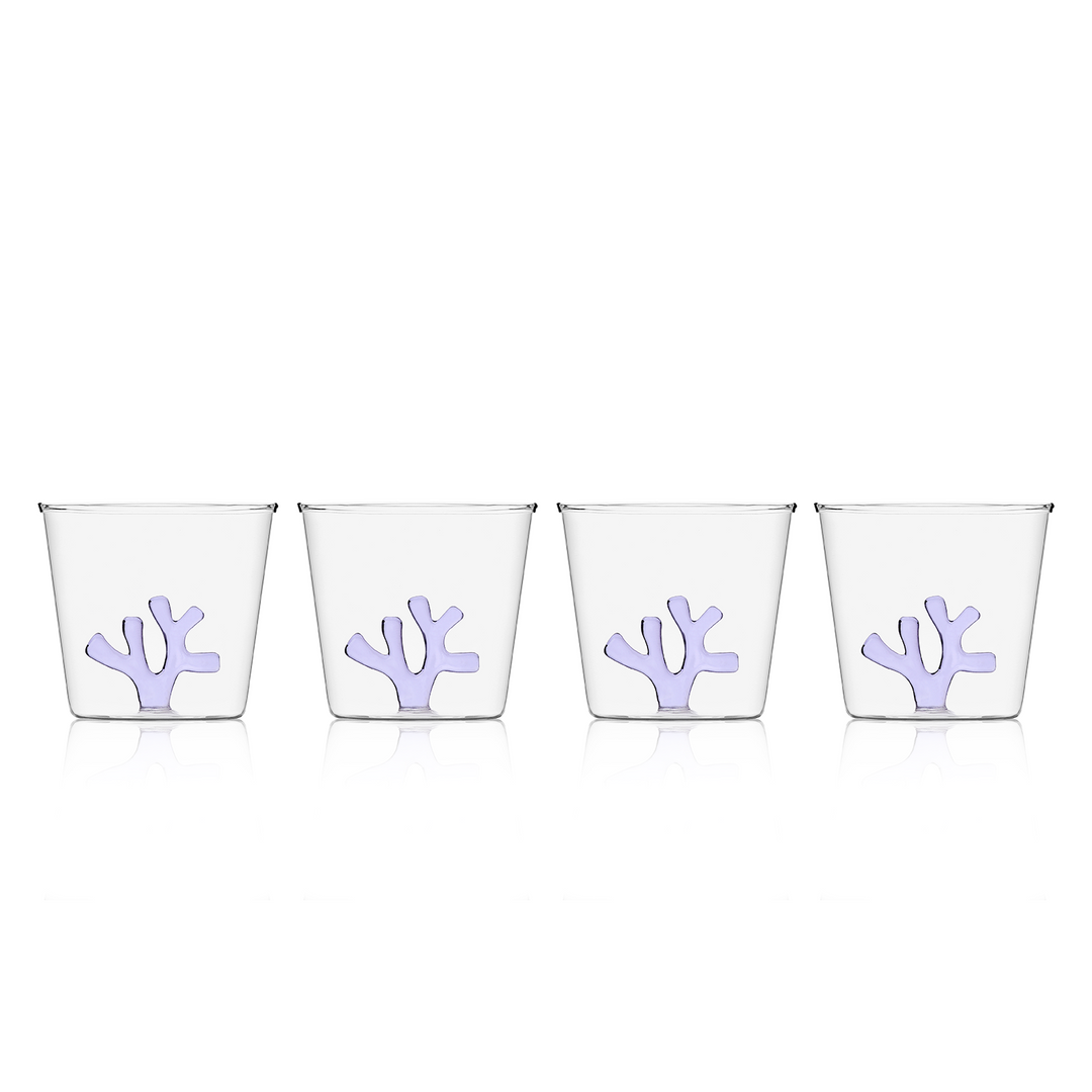 Water tumbler with clear glass and lilac coral-shaped silicone insert on front