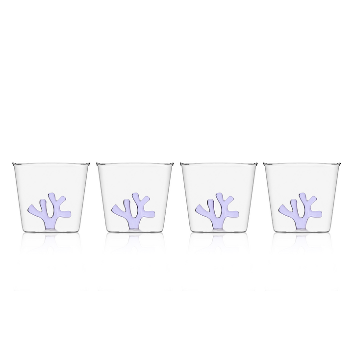 Water tumbler with clear glass and lilac coral-shaped silicone insert on front