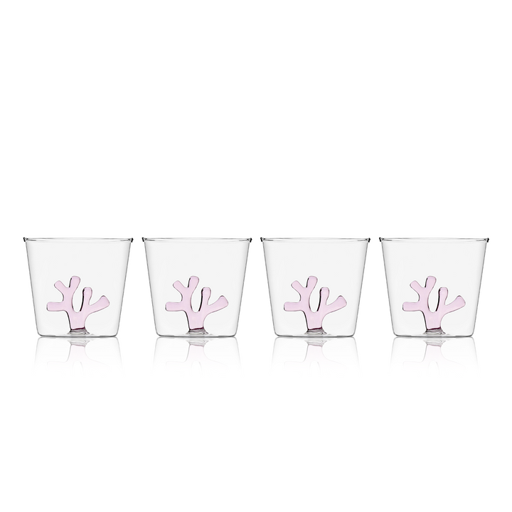 Water tumbler with clear glass and pink coral-shaped silicone insert on front