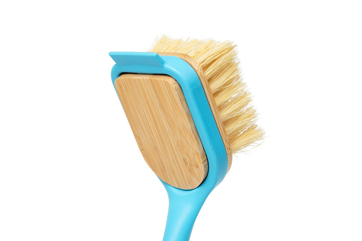 Close view of dish brush head with yellow bristles on a blue frame
