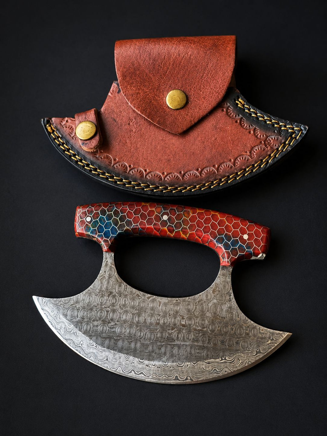 Damascus steel ulu knife with red honeycomb resin handle and brown leather crescent sheath
