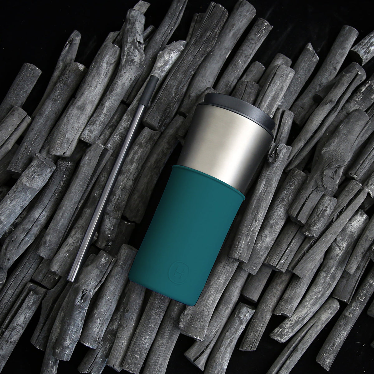 Peacock green travel mug with stainless steel cup and lid resting beside