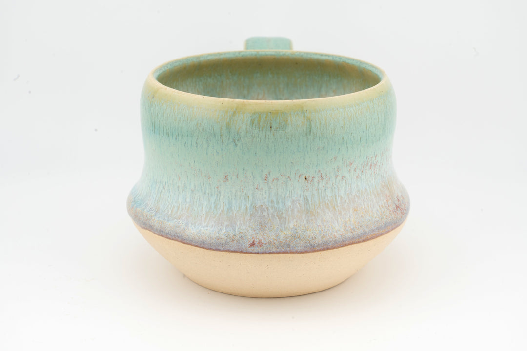 Ceramic wide mug with turquoise glaze and rounded lip, textured speckled surface