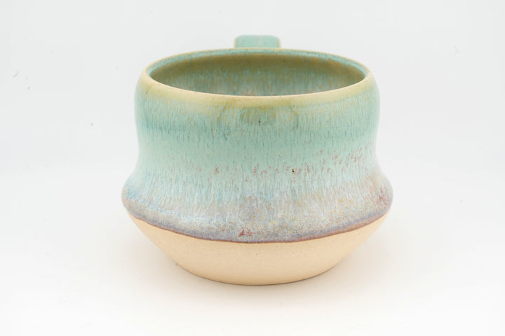 Ceramic wide mug with turquoise glaze and rounded lip, textured speckled surface