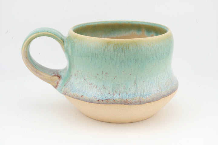 Ceramic wide mug with turquoise glaze, side view of loop handle and wide body