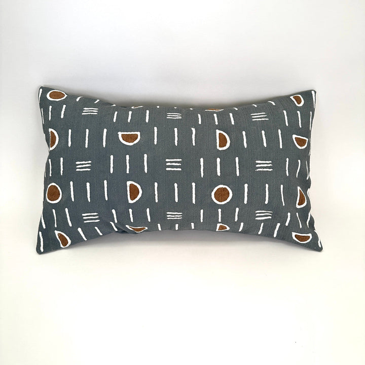 Dark gray lumbar pillow cover with white mudcloth lines and brown oval accents