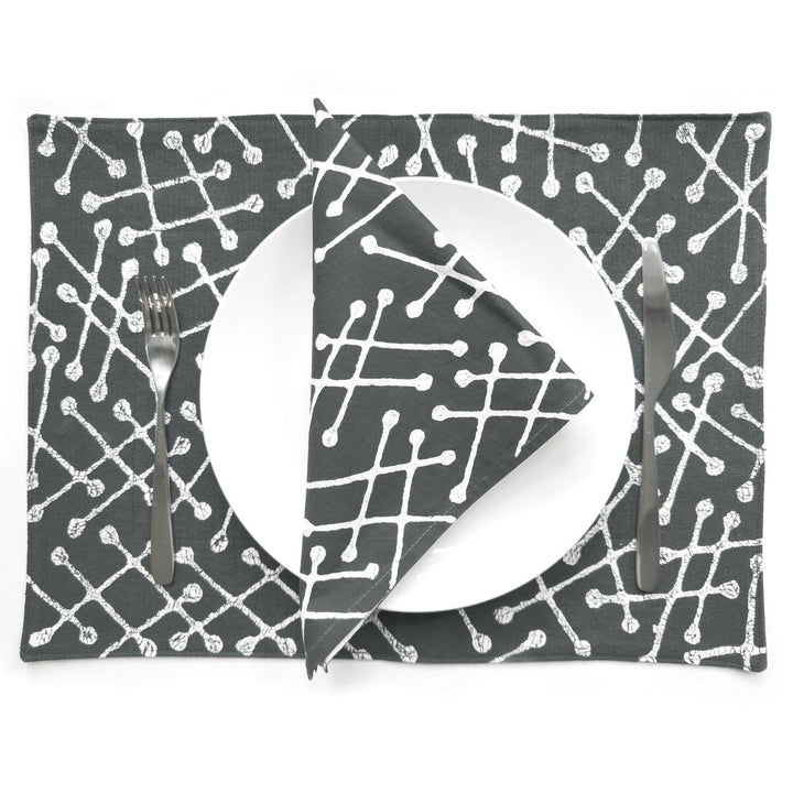 Set of 2 gray placemats with white geometric line pattern, under plate and fork