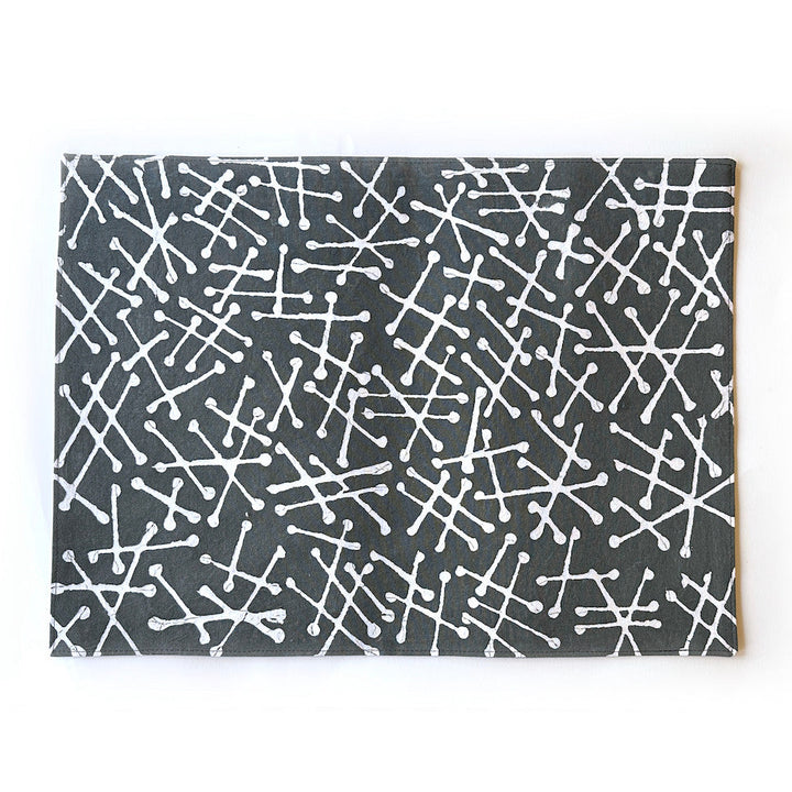 Gray placemat with white geometric line pattern, flat lay