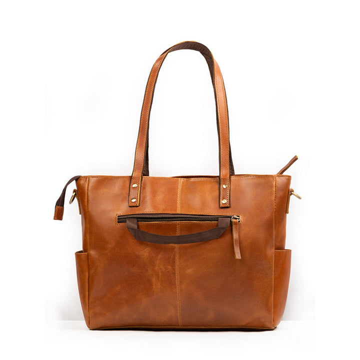 Tan leather tote bag with front magnetic-style strap tab and shoulder strap