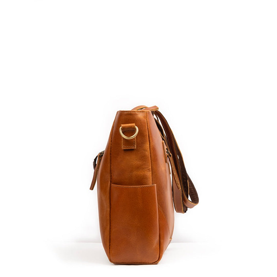 Tan leather tote bag with top handle and side drawstring pulls