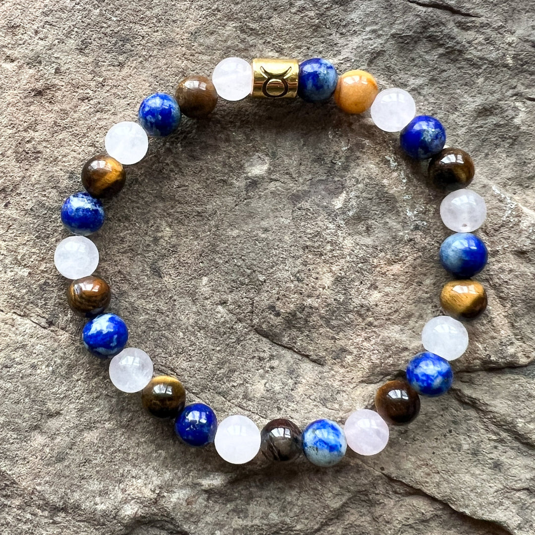 Taurus zodiac bracelet with blue round beads, white stones, brown beads, gold center
